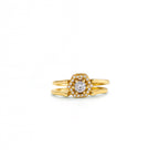 Gold ring with a diamond on a white background